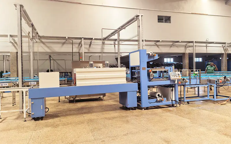 Malawi Project- kombucha bottling line- Rotary labeler and linear shrink wrapper in operation