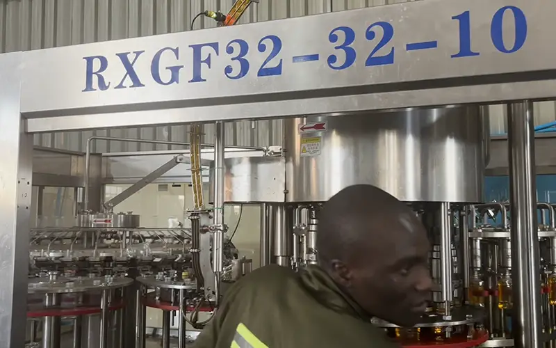 Service engineer checking the PET bottle liquor filling machine during the 2026 follow-up visit